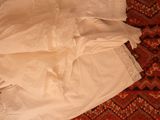 a white dress on a red rug on the floor