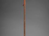 a tall wooden pole with a wooden handle on a gray background