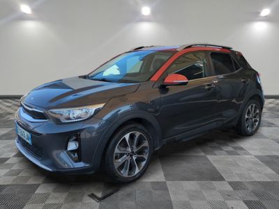a grey and red car is parked in a garage