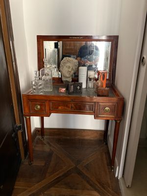 a wooden table with a mirror on top of it