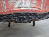 a close up of a chair with a red upholstered seat