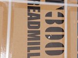 a cardboard box with a sign on it sitting on the floor