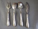 four forks and a knife on a table