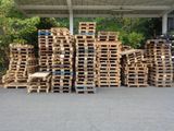 a lot of pallets that are stacked up on the ground