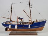 a model of a boat on display on a white surface