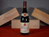 a bottle of wine sitting on a table next to two wooden boxes
