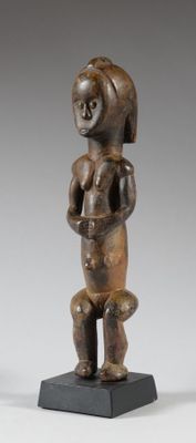 an image of a wooden statue of a woman holding a baby