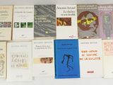 several books on a white table with a white background