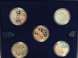 a box of six coins with a picture of a clock on it