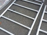 a ladder that is laying on the ground next to a car