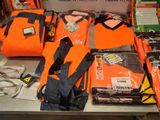 a display of orange life jackets and life jackets on a table