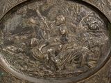 a silver plate with a picture of a man and a woman on it