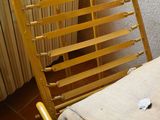 a chair that is next to a radiator in a room