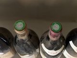 several bottles of wine are lined up in a row in the sink