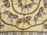 a yellow scarf with a picture of a cowboy on horseback