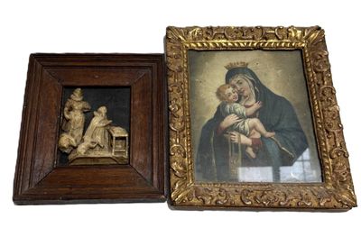 two framed paintings of a woman holding a baby and a man holding a child