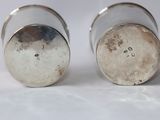 pair of silver salt and pepper shakers on a white surface