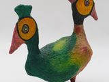 a colorful bird with a hat on it ' s head
