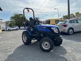 a blue tractor parked in a parking lot next to a parking lot
