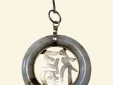 a picture of a necklace with a picture of a person on it