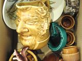 a cardboard box with a lot of pottery items in it