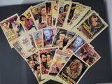 a lot of old movie posters on the table