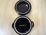 two black pots sitting on a wooden table