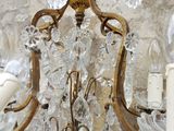 a chandelier that is hanging from a stone wall