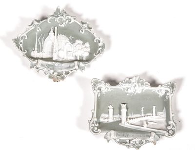 two plaques with a picture of a city on them