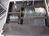 many forks and spoons in a case on a table