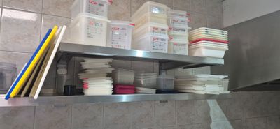 a metal shelf that has a bunch of plates and cups on it