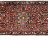 tapis persan ancien à motif floral sur fond rouge