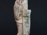 statue of a woman in a kimono dress holding a fan