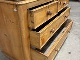 a wooden dresser with three drawers and a mirror on top