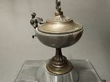 a silver bowl with a bird on top of it