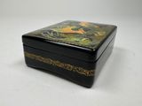 an image of a black and gold box with a bird on it