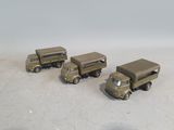four toy army vehicles that are sitting on a table