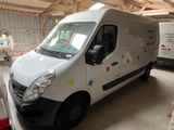 une camionnette blanche garée à l'intérieur d'un bâtiment