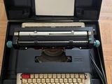 an old typewriter sitting in a case on the floor