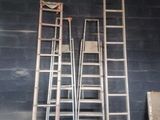 three ladders that are leaning against a wall
