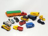a lot of toy cars and trucks on a white surface
