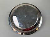 a close up of a silver plate on a table
