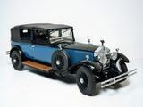 a blue and black model of a car on a white surface