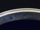 a close up view of a metal bowl with a black background