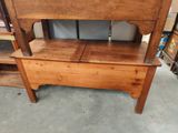 a wooden bench with a wooden seat on top of it