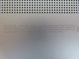 the back of a silver cell phone with a black screen