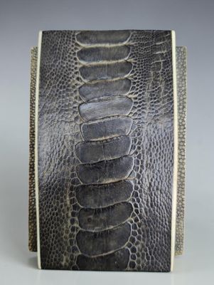 a close up of a black and white snake skin wallet