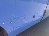 a blue van that is parked on the side of the road