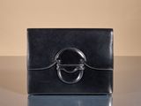 an image of a black purse on a table