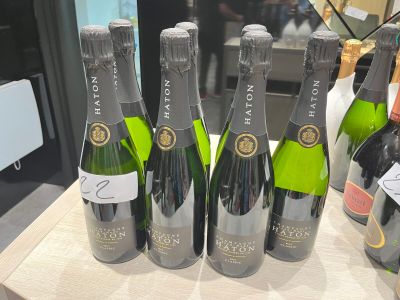 plusieurs bouteilles de champagne posées sur une table, avec une étiquette de prix